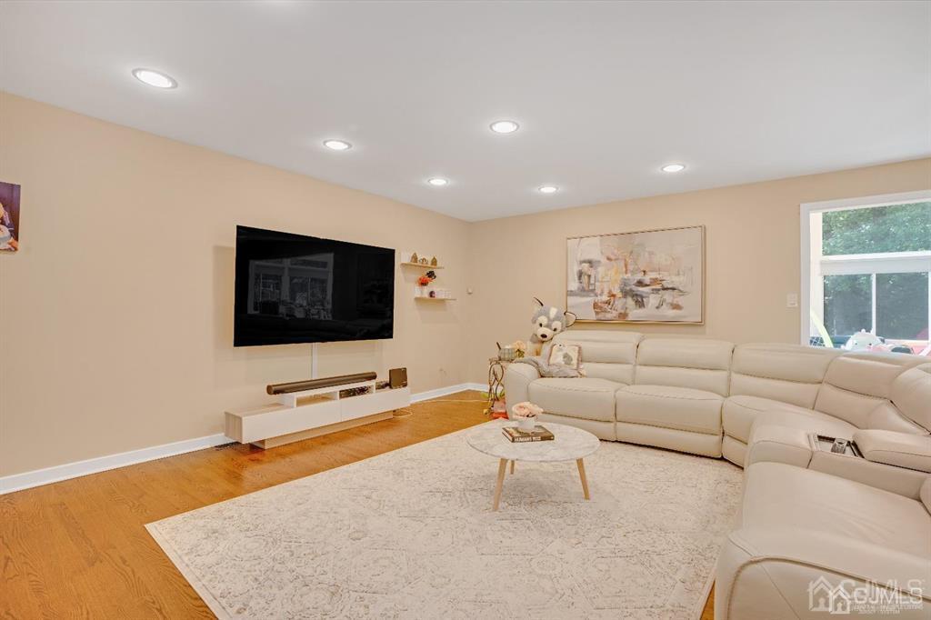 3 Clive Hills Road Edison, NJ 08820 - Photo 8 of 39 a living room with furniture and a flat screen tv