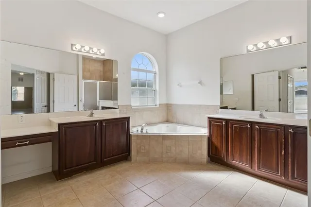 a bathroom with a granite countertop sink shower and a mirror