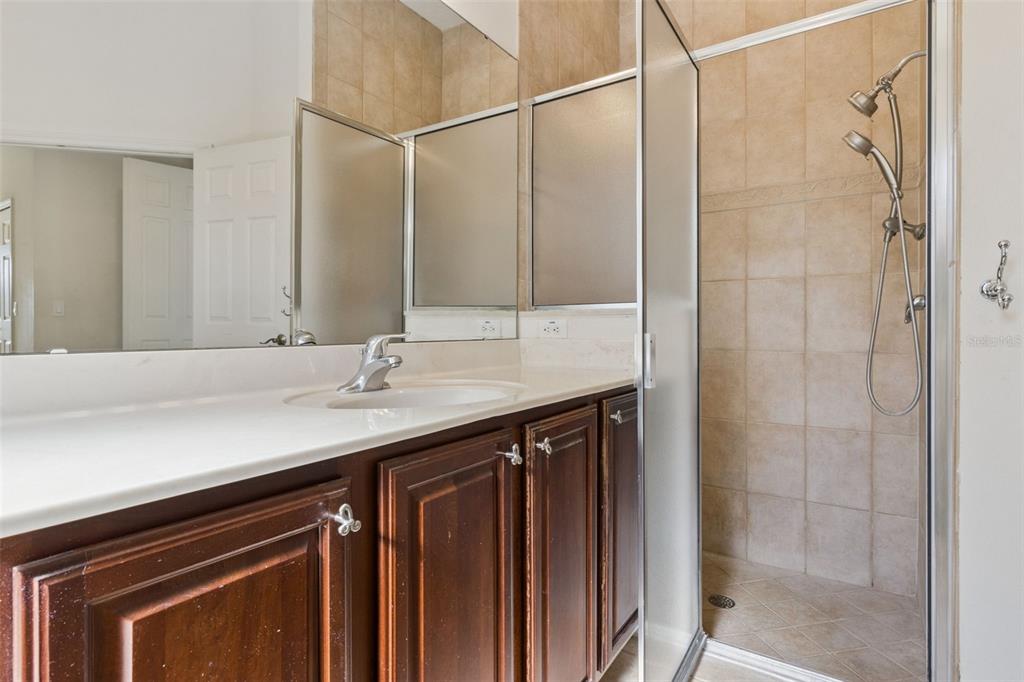 3643 Peaceful Valley Drive Clermont, FL 34711 - Photo 14 of 52 a bathroom with a granite countertop sink shower and a mirror