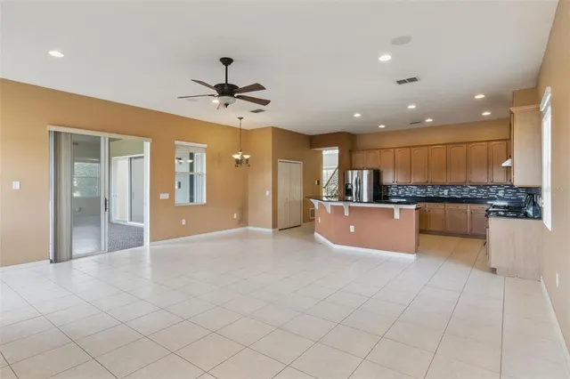a kitchen with stainless steel appliances granite countertop a refrigerator and a stove top oven