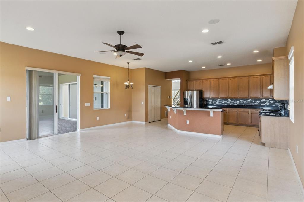 3643 Peaceful Valley Drive Clermont, FL 34711 - Photo 19 of 52 a large kitchen with stainless steel appliances kitchen island granite countertop a large counter top and granite top