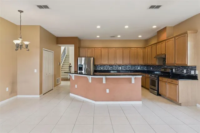 a kitchen with stainless steel appliances granite countertop a sink and cabinets