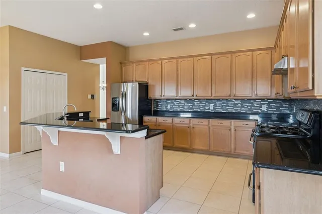 a bathroom with a granite countertop sink a toilet and shower