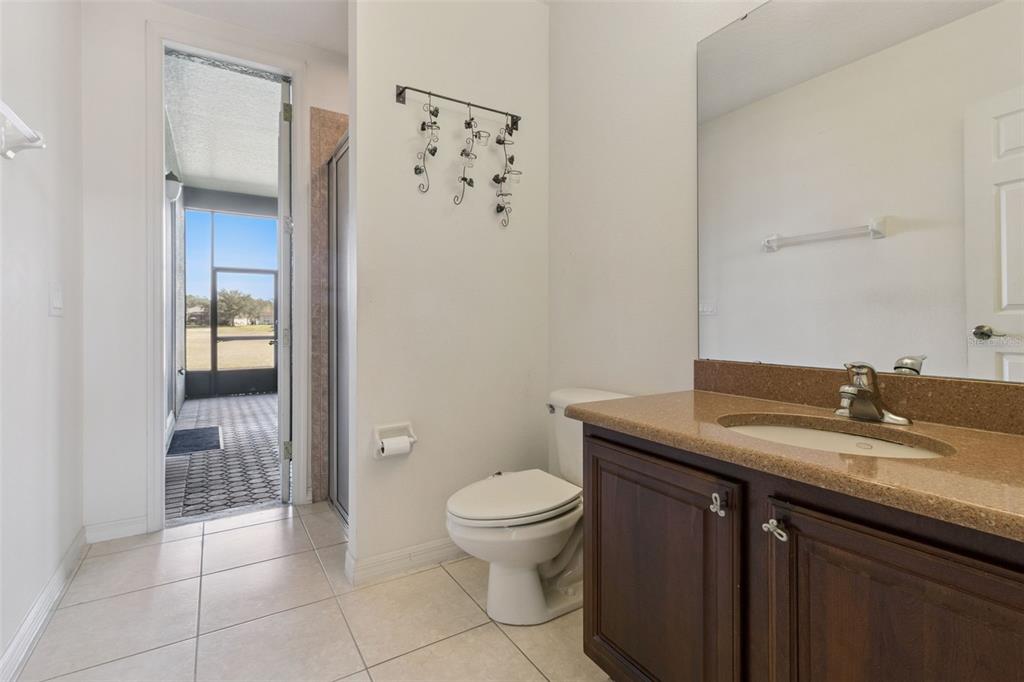 3643 Peaceful Valley Drive Clermont, FL 34711 - Photo 23 of 52 a bathroom with a granite countertop sink a toilet and shower
