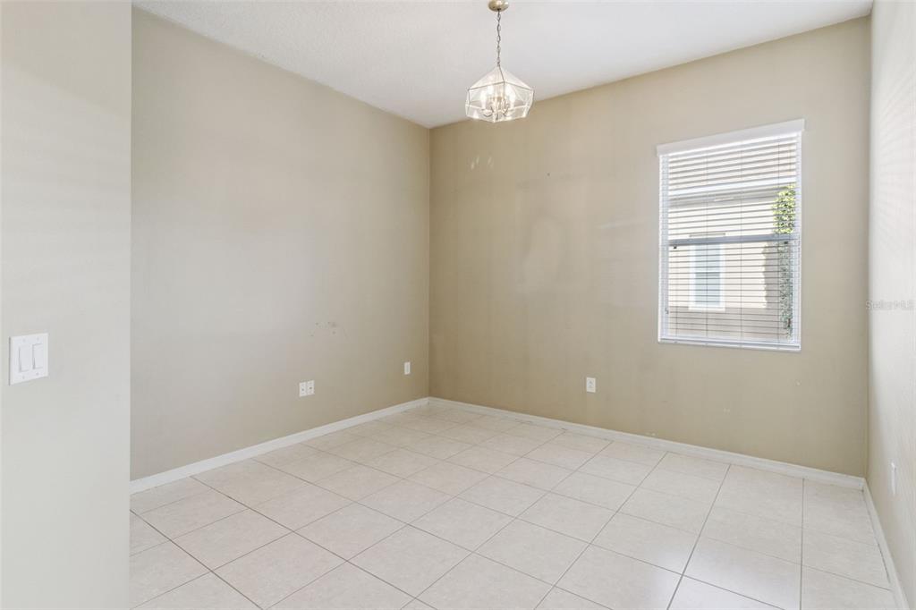 3643 Peaceful Valley Drive Clermont, FL 34711 - Photo 27 of 52 en empty room with windows and chandelier