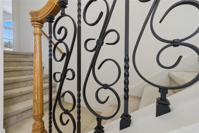 a view of an empty room with closet and a window