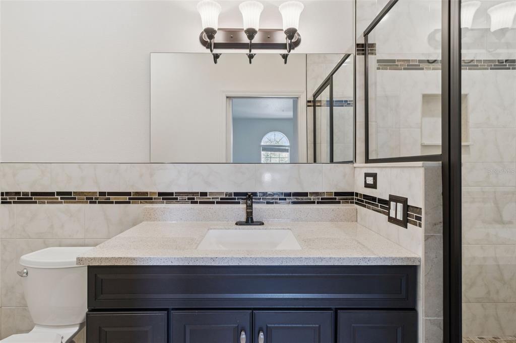 3643 Peaceful Valley Drive Clermont, FL 34711 - Photo 33 of 52 a bathroom with a sink and a mirror