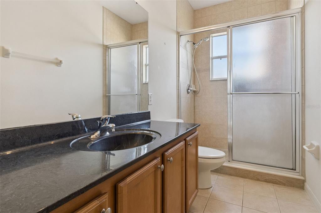 3643 Peaceful Valley Drive Clermont, FL 34711 - Photo 35 of 52 a bathroom with a granite countertop sink and a mirror