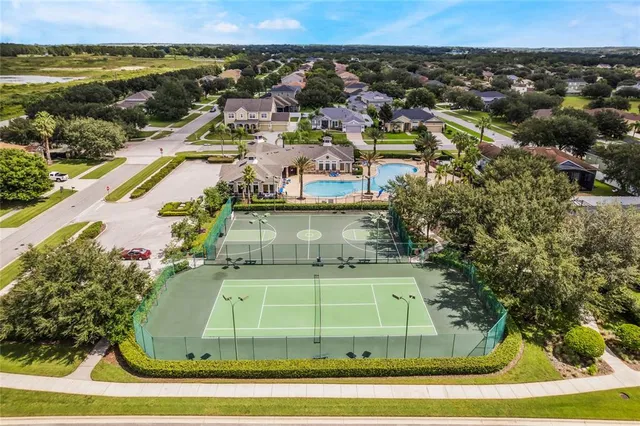 an aerial view of swimming pool patio and outdoor seating