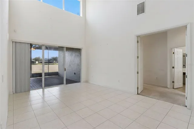 a view of a hallway with wooden floor and a bathroom