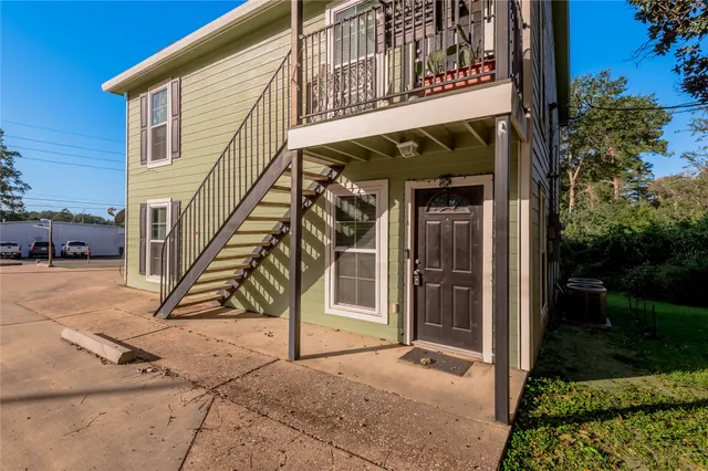 a view of a kitchen with a sink and a refrigerator