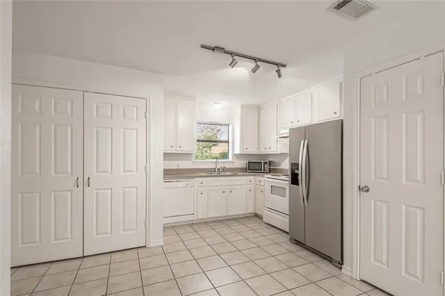 a bathroom with a granite countertop sink mirror and toilet