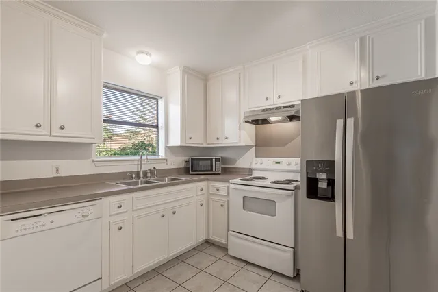 a view of washer and dryer with bathroom in the background