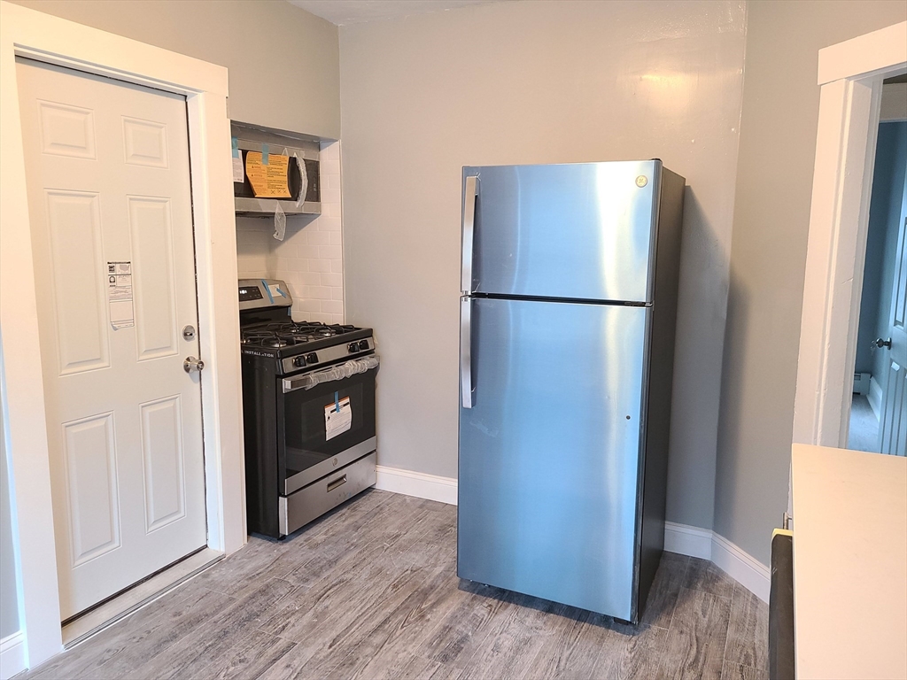 64 Stockton Street Boston, MA 02124 - Photo 15 of 27 a view of kitchen with stainless steel appliances a refrigerator and cabinets
