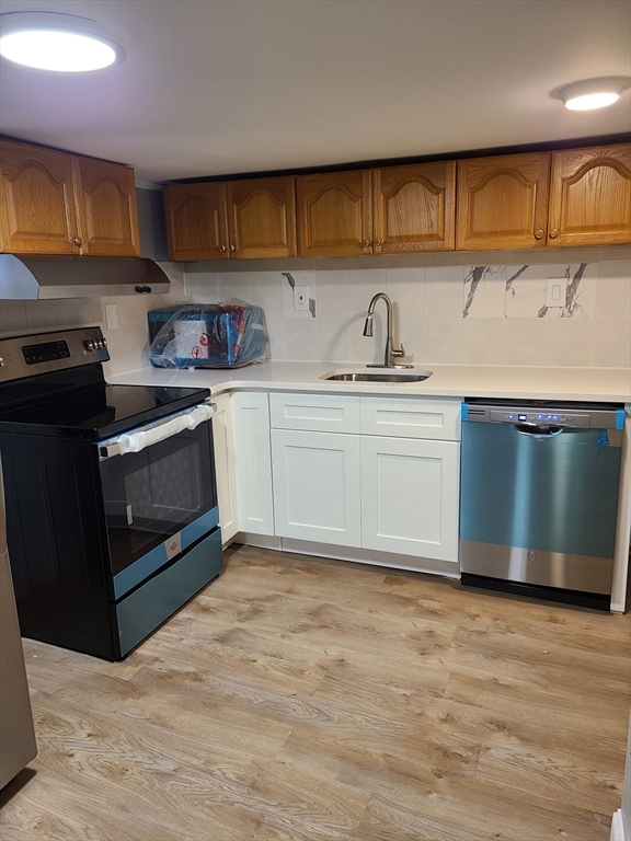 64 Stockton Street Boston, MA 02124 - Photo 22 of 27 a kitchen with stainless steel appliances granite countertop a stove a sink and a microwave