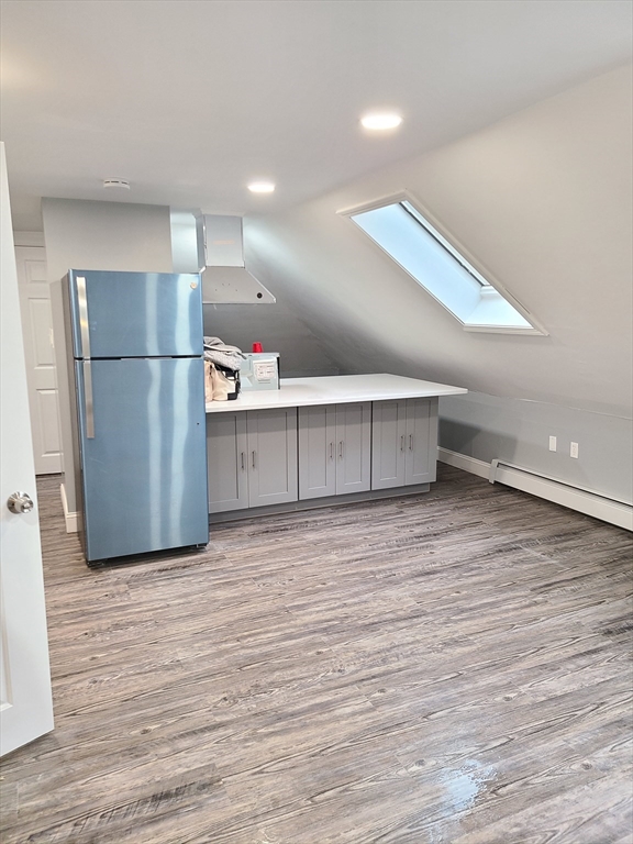 64 Stockton Street Boston, MA 02124 - Photo 4 of 27 a view of kitchen with refrigerator and wooden floor