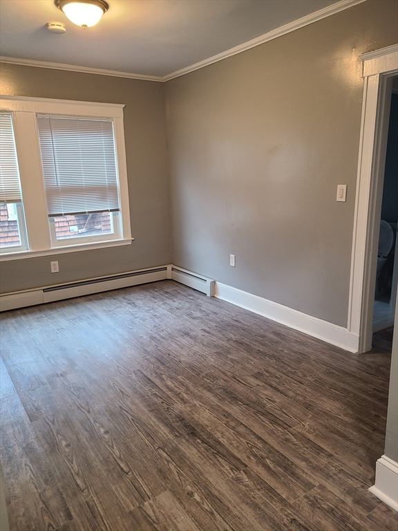 64 Stockton Street Boston, MA 02124 - Photo 10 of 27 a view of an empty room with wooden floor and a window