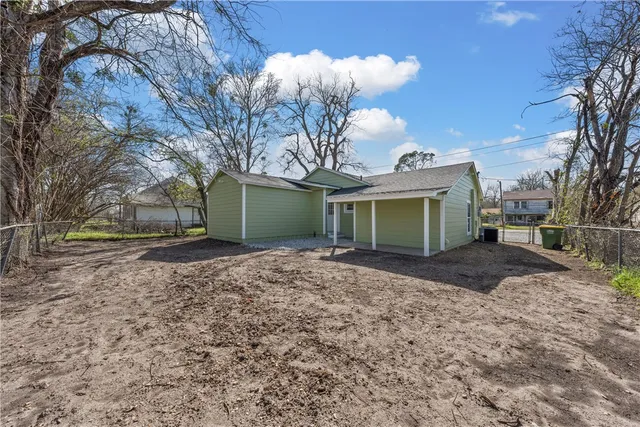 a view of a house with a yard and garage