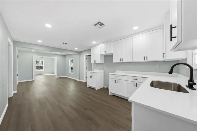 a kitchen with a sink a stove and cabinets