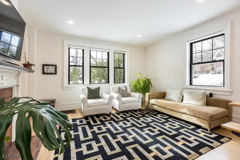 a living room with furniture and a floor to ceiling window