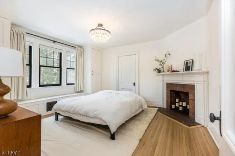 a bedroom with a bed and a fireplace