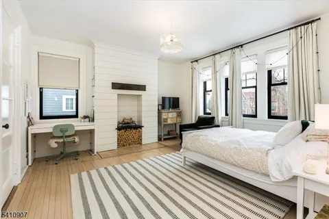 a bedroom with a large bed and a chandelier