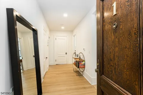a view of hallway with wooden floor