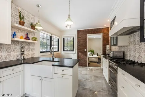 a kitchen with a sink stove and cabinets