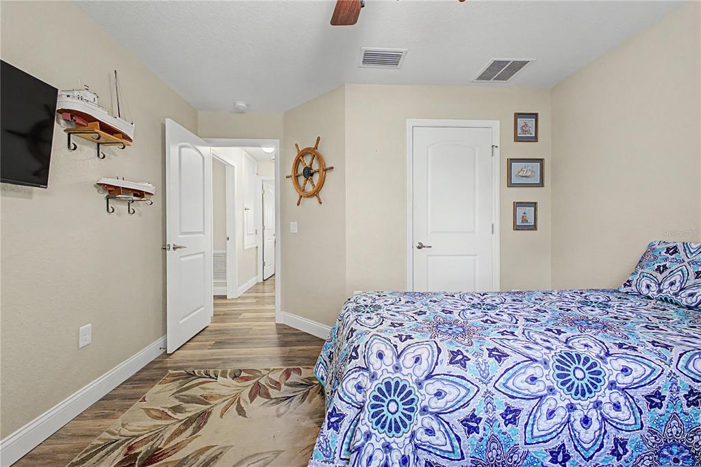 11213 Flock Avenue Weeki Wachee, FL 34613 - Photo 30 of 46 a bedroom with a large bed and a dresser