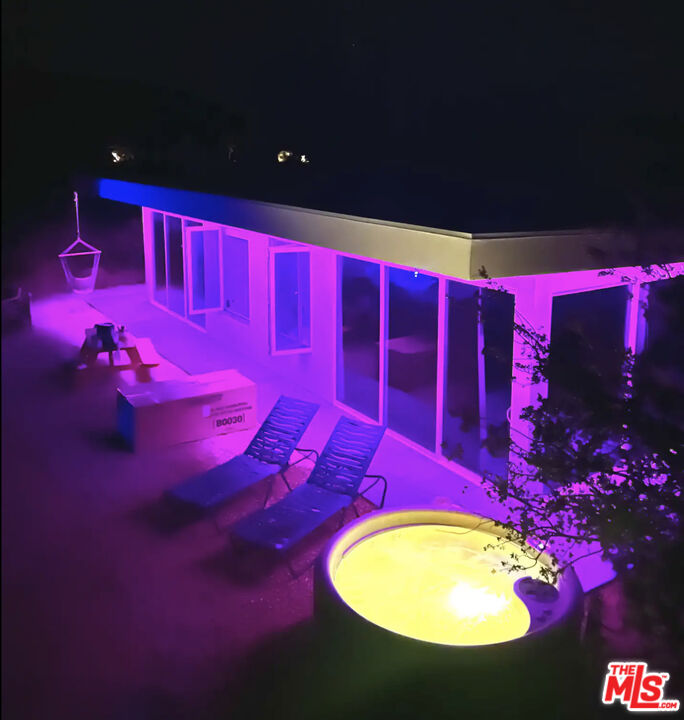 a swimming pool with red chairs