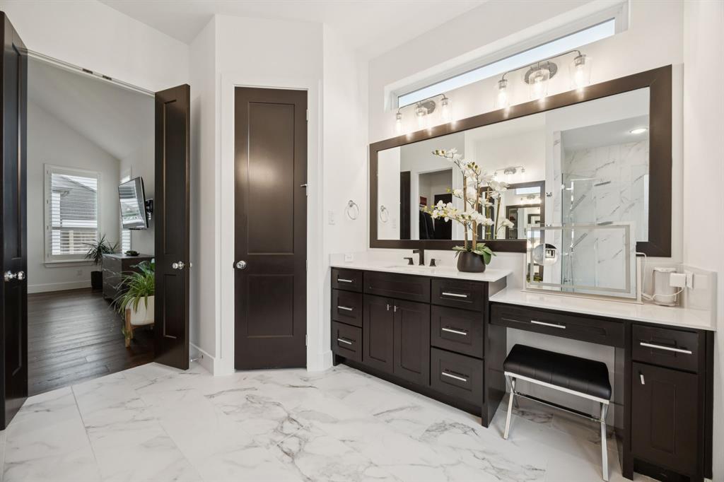 7024 Prairie Ridge Road Argyle, TX 76226 - Photo 25 of 40 Bathroom Features Custom Dark Wood Vanities Paired with Elegant Lighting