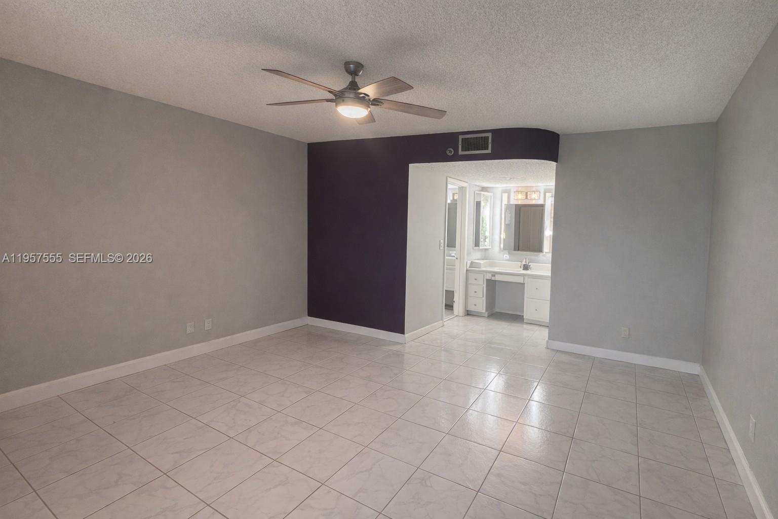 3910 Inverrary Boulevard, Unit 603B Lauderhill, FL 33319 - Photo 5 of 10 a view of an empty room with a chandelier fan