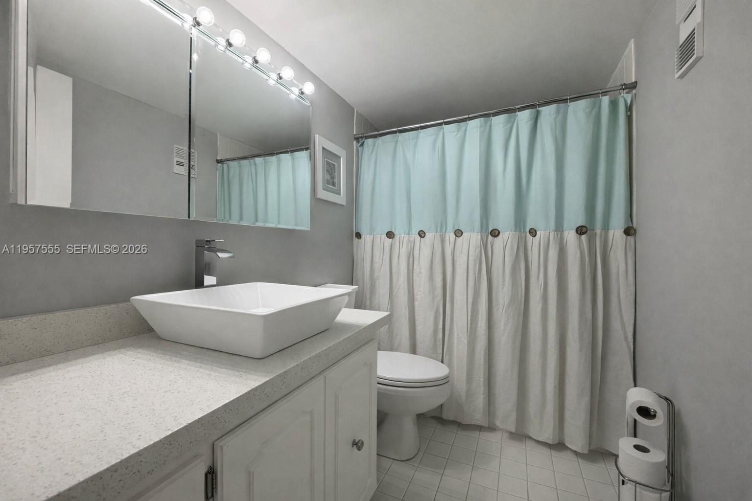 3910 Inverrary Boulevard, Unit 603B Lauderhill, FL 33319 - Photo 9 of 10 a bathroom with a sink a toilet and shower