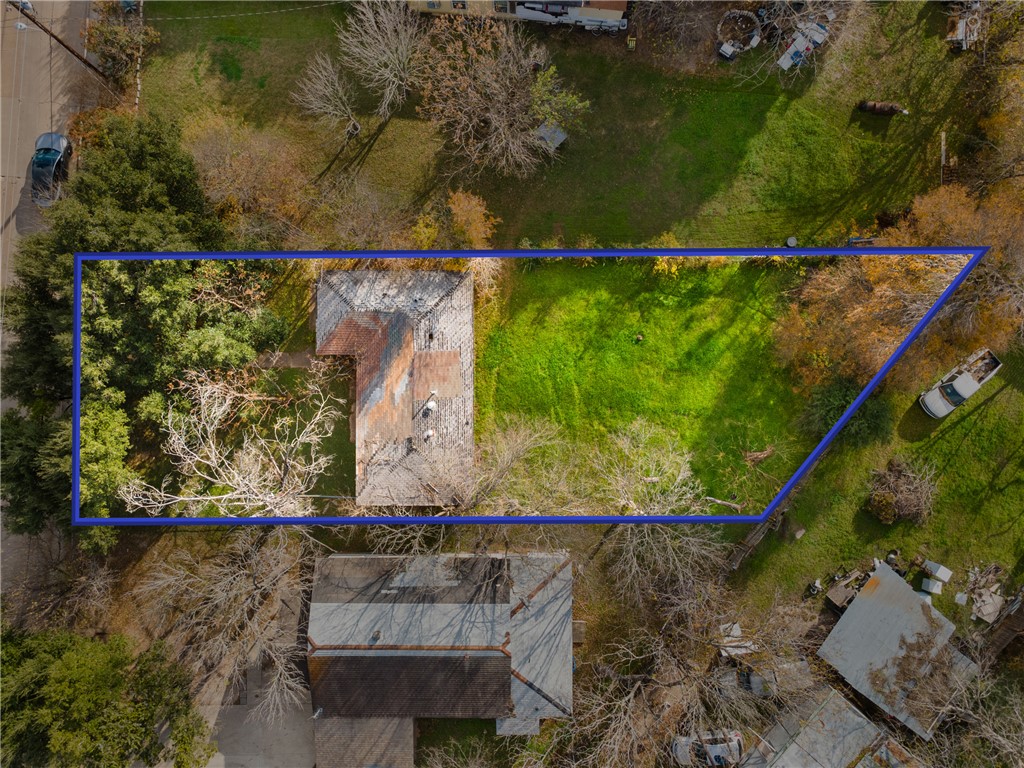 an aerial view of a residential houses with outdoor space