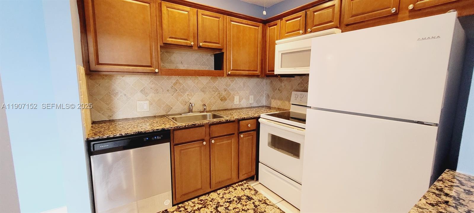 534 Mansfield M, Unit 534 Boca Raton, FL 33434 - Photo 11 of 52 a kitchen with stainless steel appliances a refrigerator and a stove