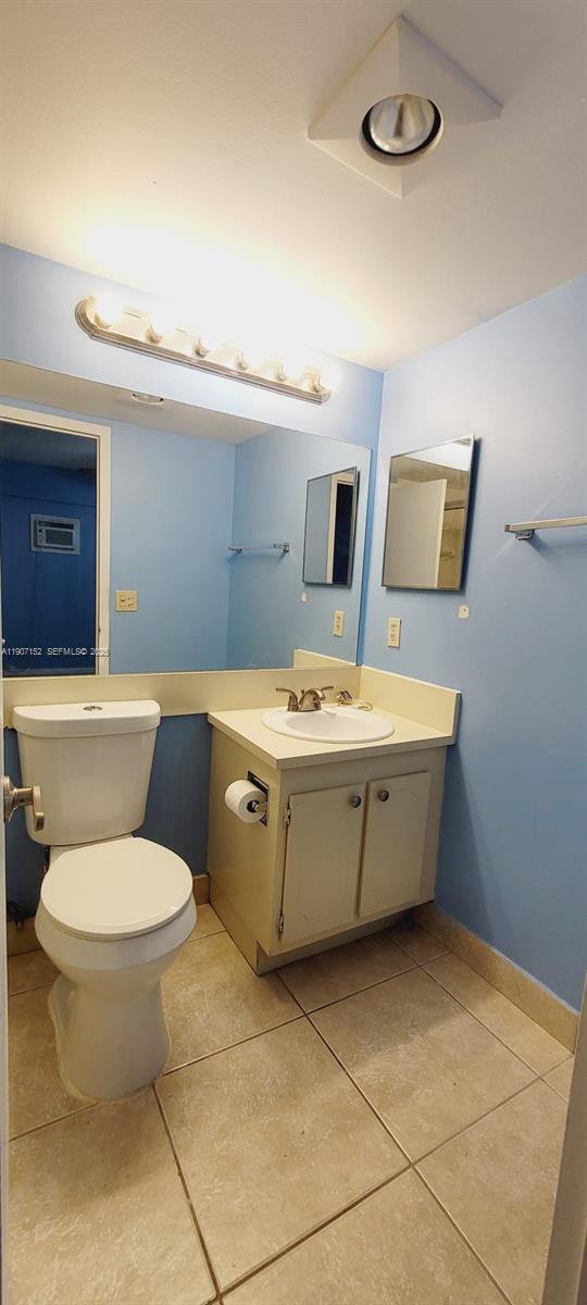534 Mansfield M, Unit 534 Boca Raton, FL 33434 - Photo 21 of 52 a bathroom with a toilet sink and mirror