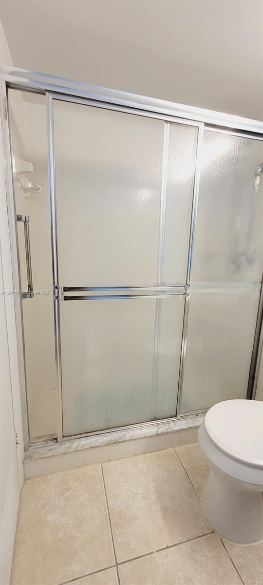 534 Mansfield M, Unit 534 Boca Raton, FL 33434 - Photo 22 of 52 a bathroom with a shower and a toilet