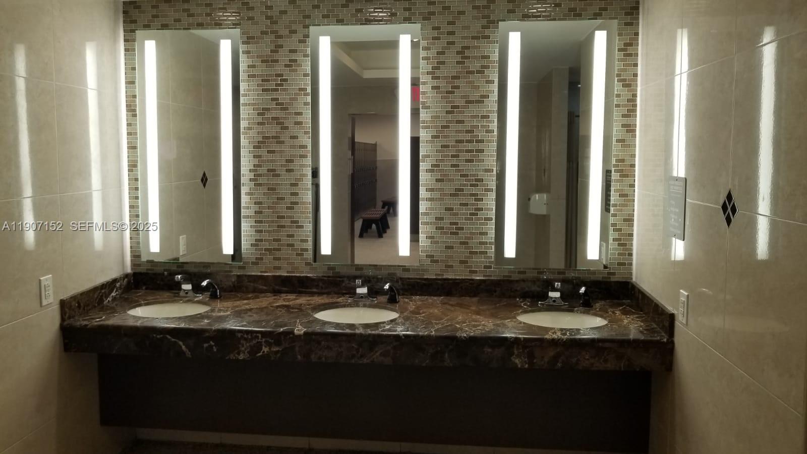 534 Mansfield M, Unit 534 Boca Raton, FL 33434 - Photo 31 of 51 a bathroom with a sink and a mirror