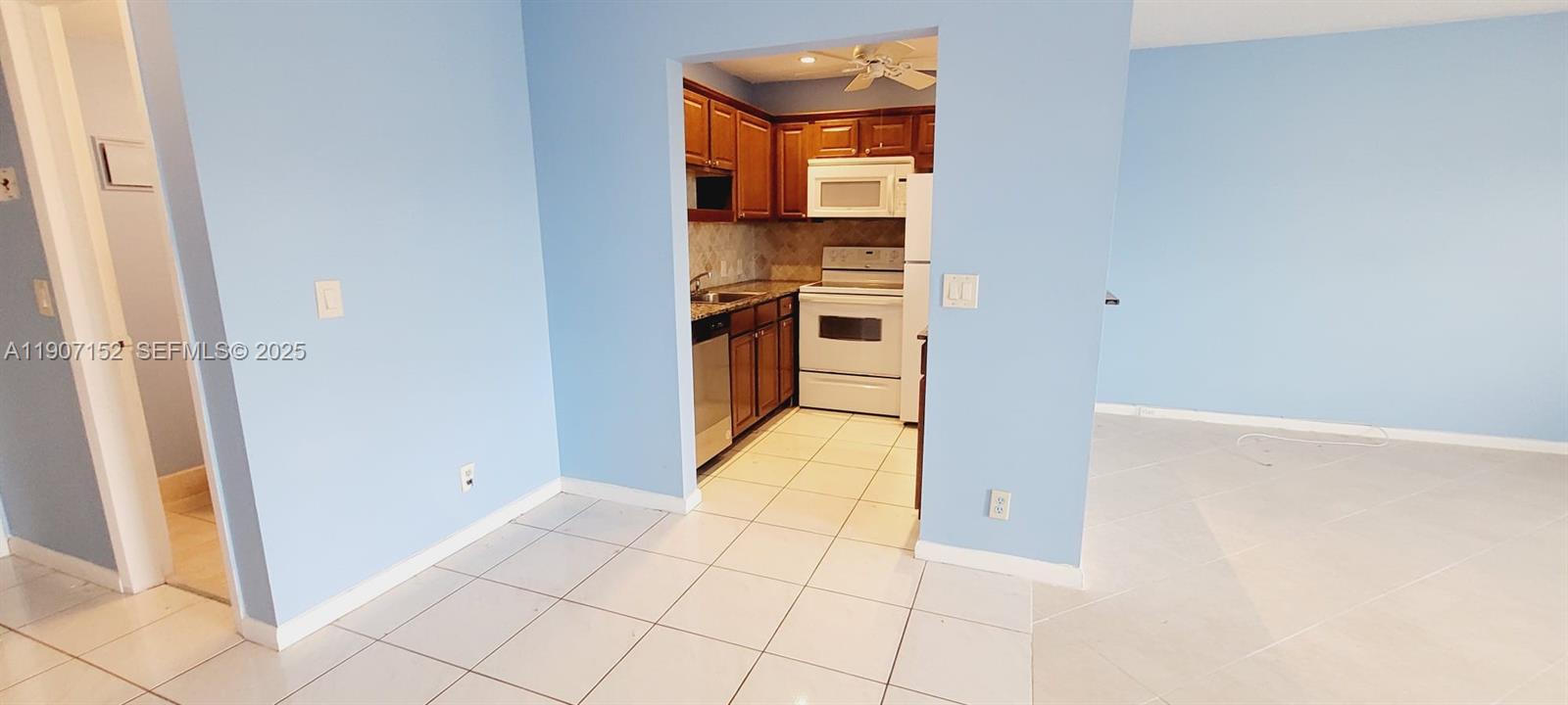 534 Mansfield M, Unit 534 Boca Raton, FL 33434 - Photo 6 of 51 a view of a kitchen from the hallway
