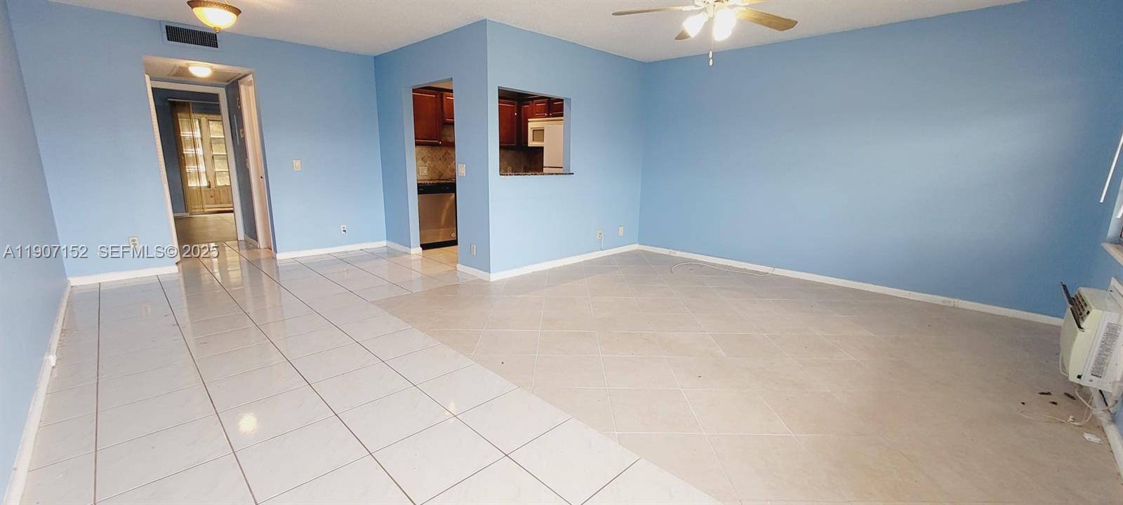 534 Mansfield M, Unit 534 Boca Raton, FL 33434 - Photo 6 of 52 an empty room with chandelier fan