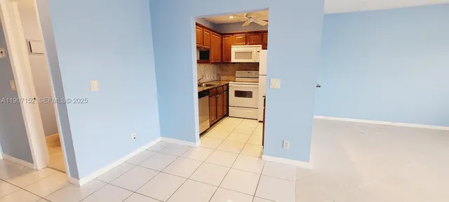 a view of a kitchen from the hallway