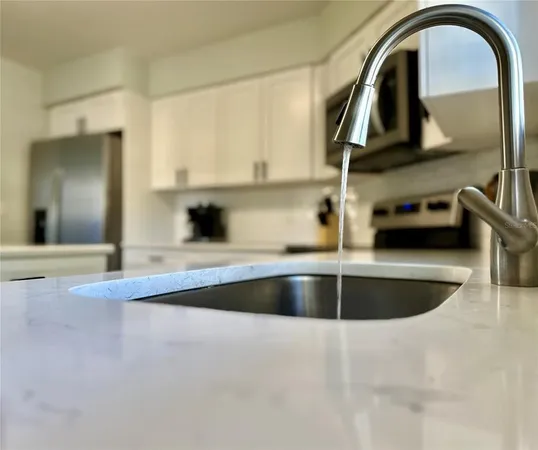 a kitchen with a sink and a stove