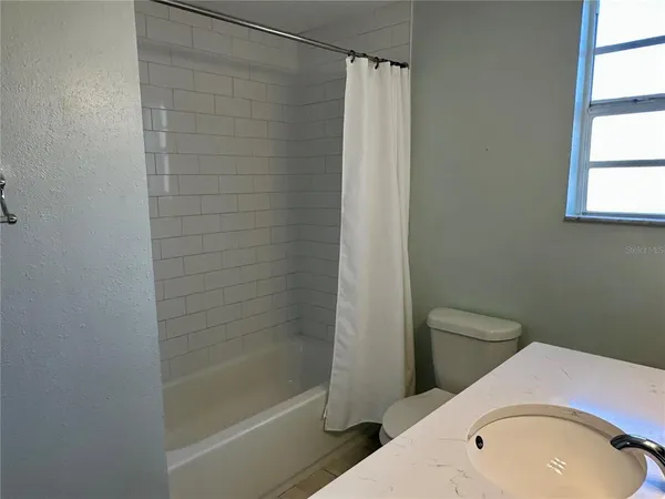 a bathroom with a toilet and shower