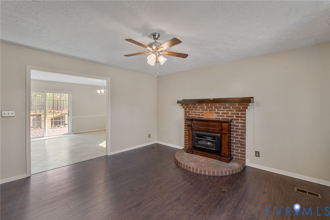 270 Long Acre Road Palmyra, VA 22963 - Photo 3 of 19 a view of an empty room with wooden floor fireplace and a window