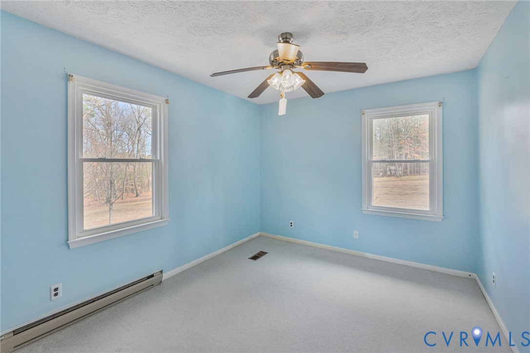 270 Long Acre Road Palmyra, VA 22963 - Photo 7 of 19 an empty room with a window and a fan
