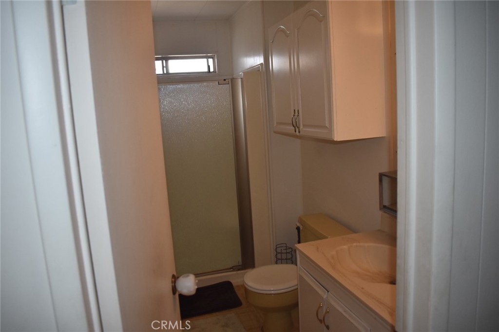 525 North Gilbert, Unit 106 Anaheim, CA 92801 - Photo 14 of 18 a bathroom with a granite countertop sink toilet and shower