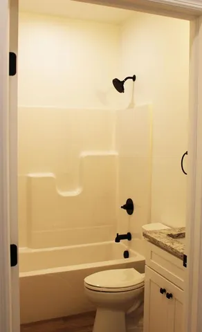 a bathroom with a toilet a sink and a bathtub