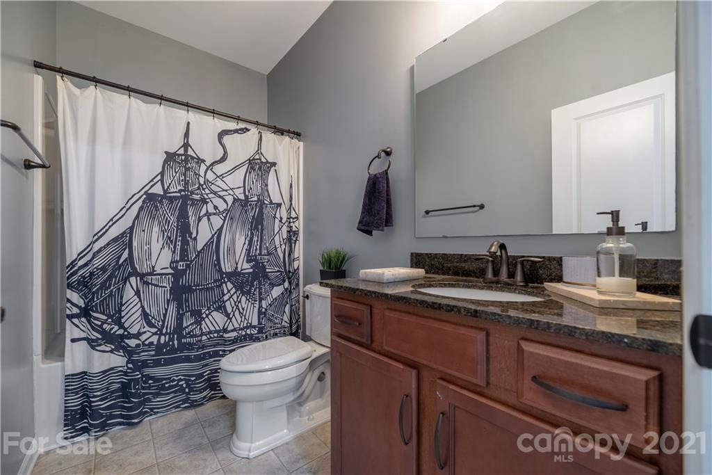 8049 Bryson Road, Unit 117 Indian Land, SC 29707 - Photo 11 of 40 a bathroom with a granite countertop sink toilet and shower