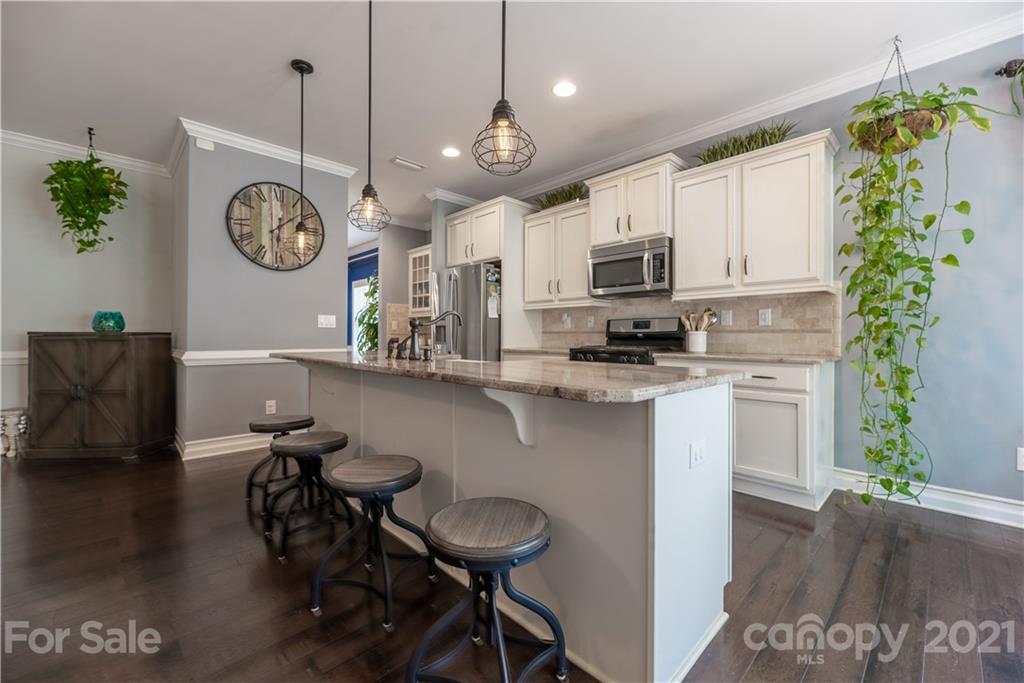 8049 Bryson Road, Unit 117 Indian Land, SC 29707 - Photo 16 of 40 a kitchen with a table and chairs in it