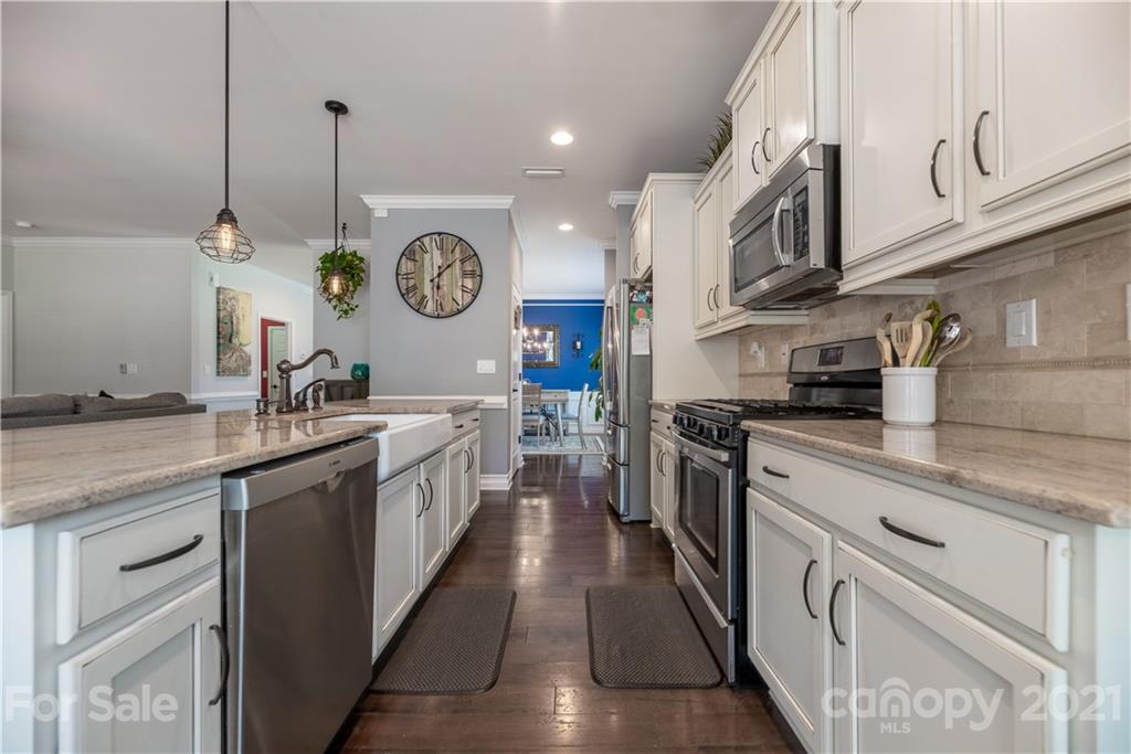 8049 Bryson Road, Unit 117 Indian Land, SC 29707 - Photo 18 of 40 a large kitchen with stainless steel appliances granite countertop a lot of counter space and a sink